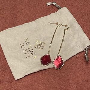 Kendra Scott long gold earrings with a  pink stone